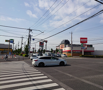 交差点の右前方に快活CLUB成田ニュータウン店が見えます。